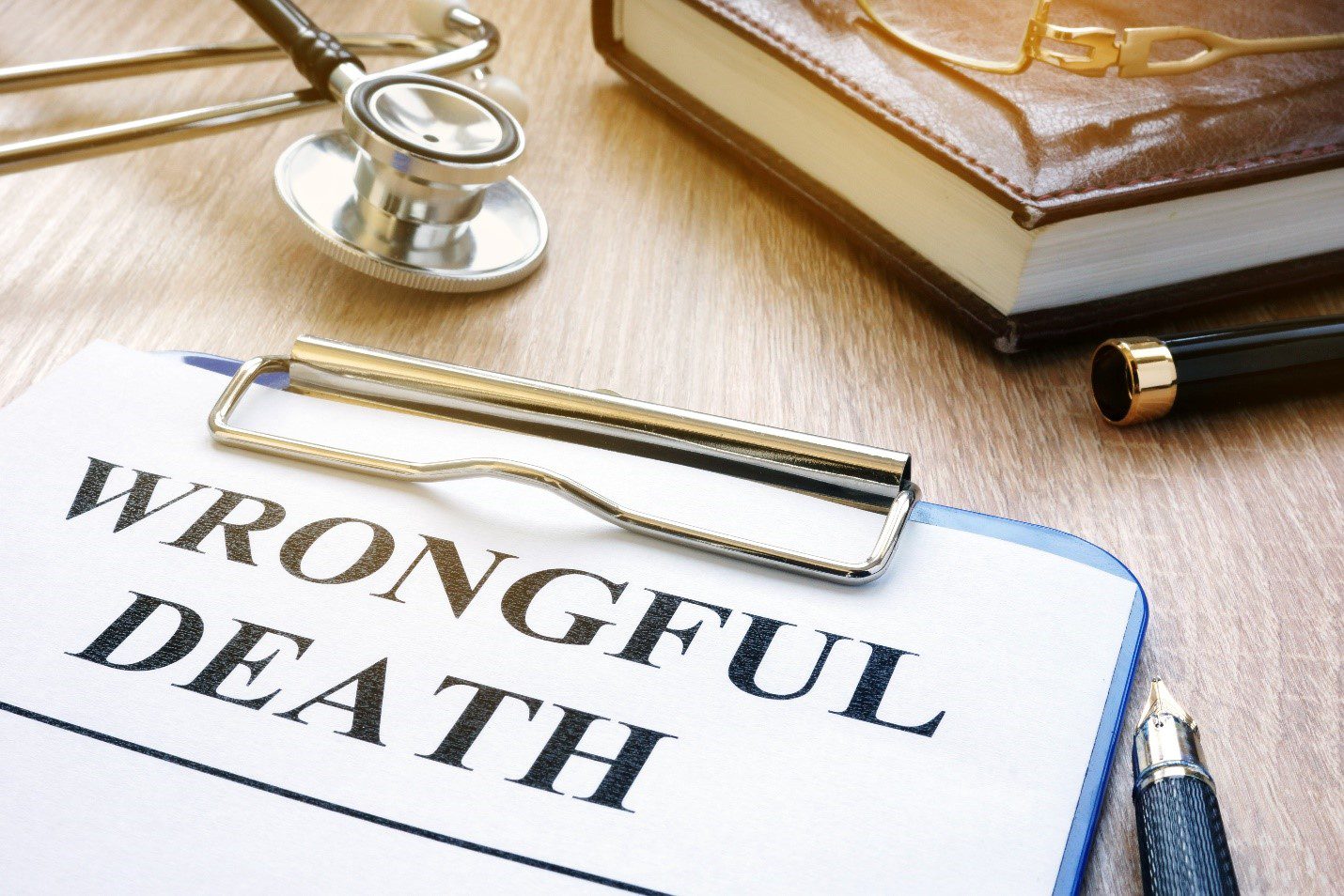 Wrongful death concept image with stethoscope and law book