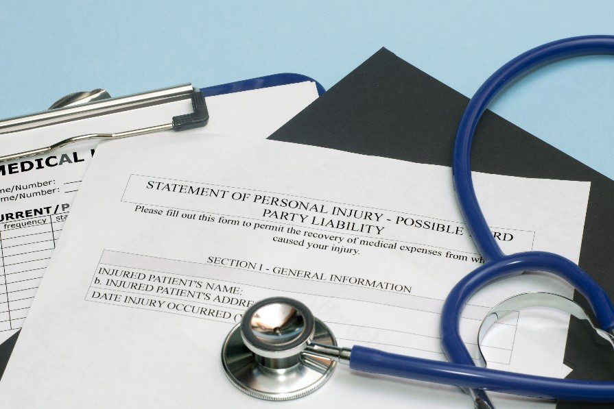 Personal injury claim forms with a stethoscope