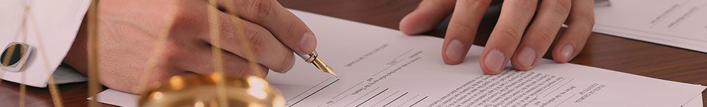 man signing a document