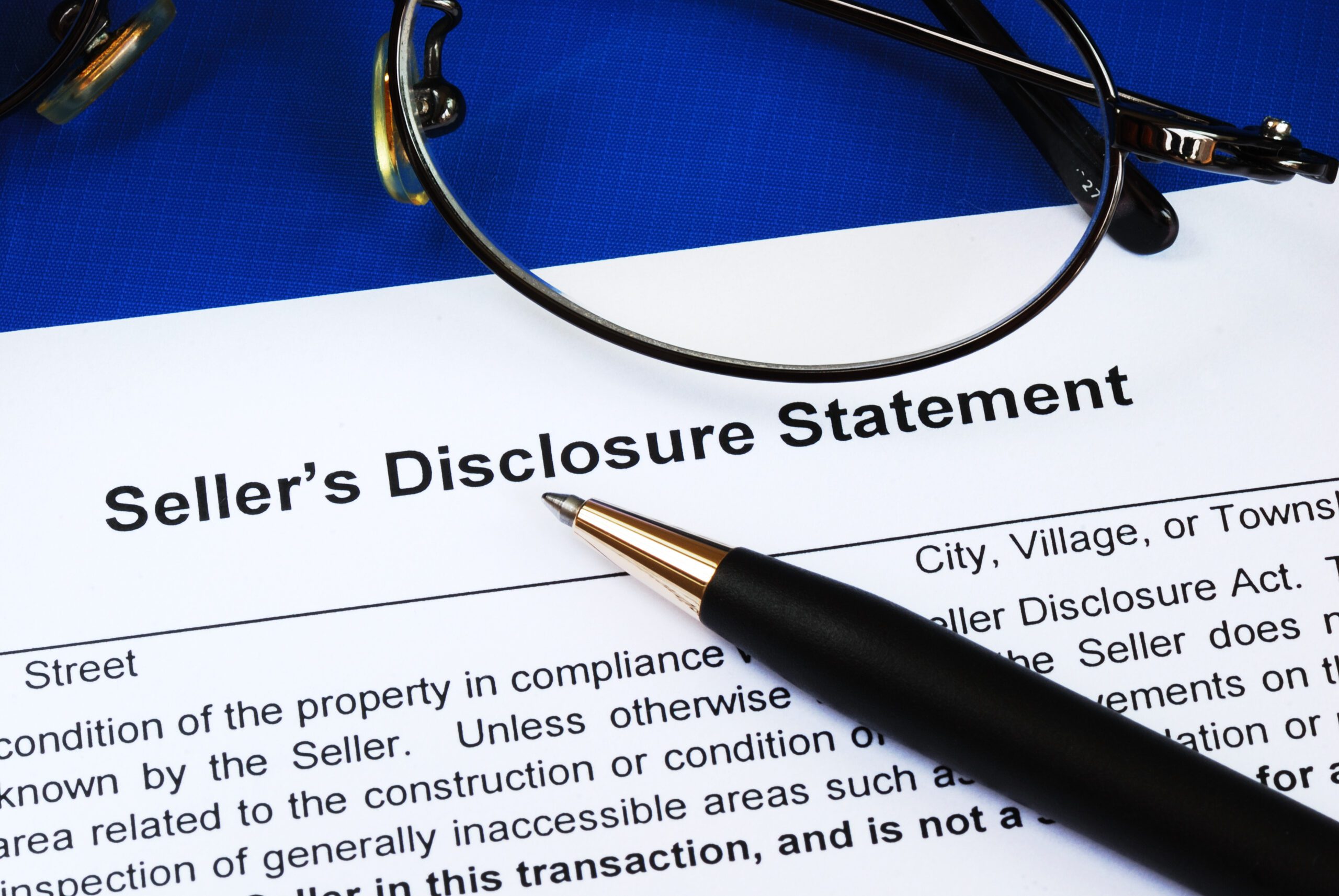 a pen on a seller’s disclosure statement