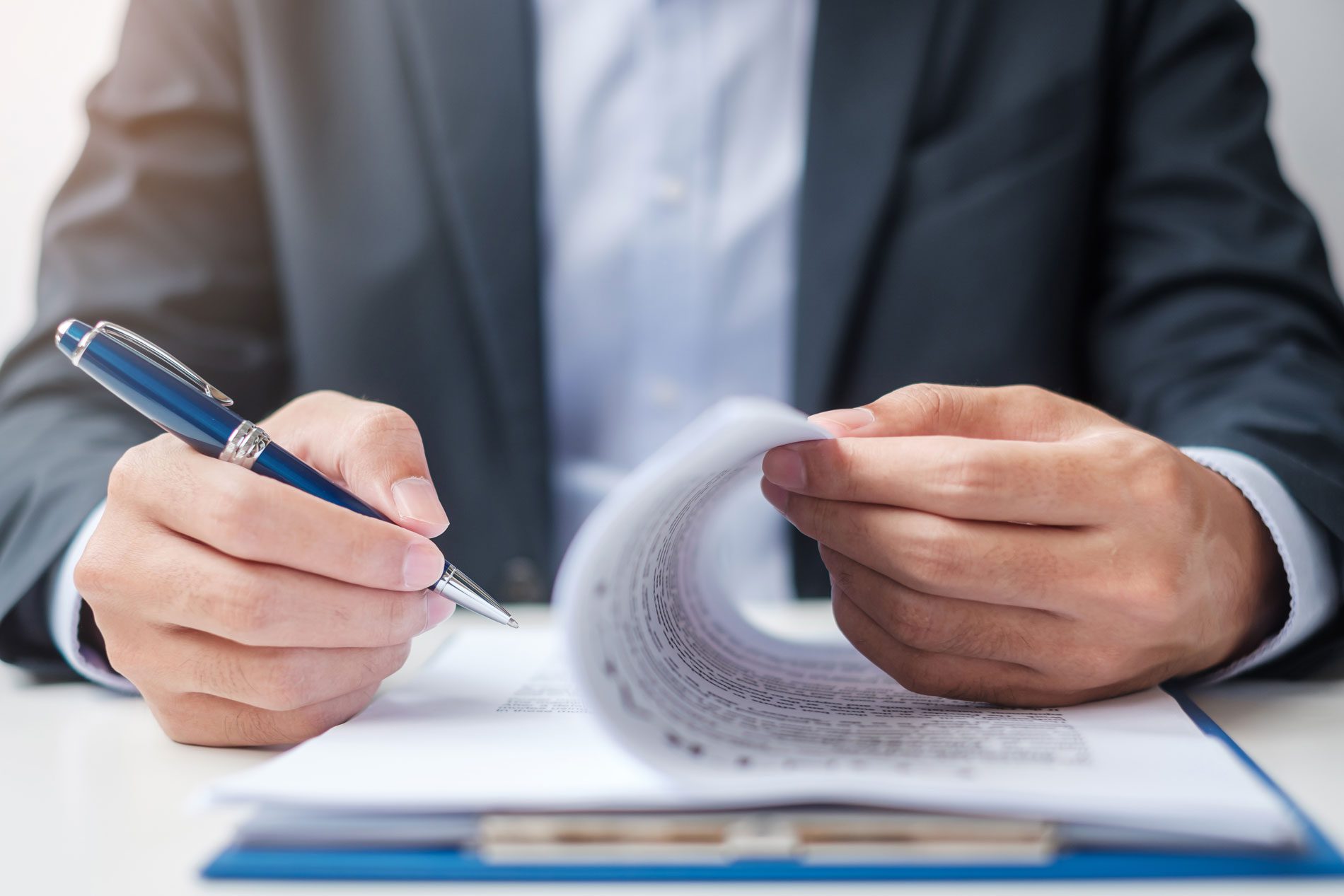 Businessman signing on contract documents after reading, man holding pen and approve on business report