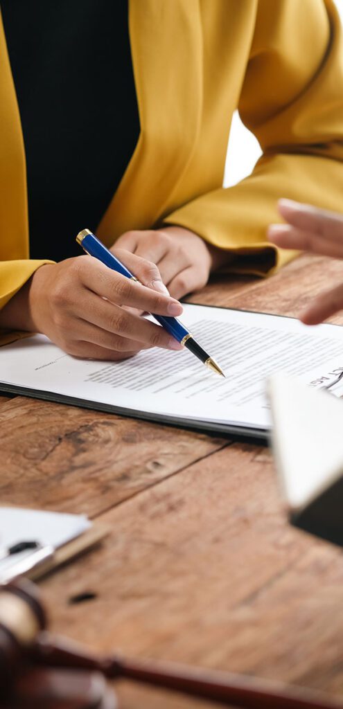 Lawyer is explaining contract details to client at a meeting in the office. They are discussing terms of agreement before signing